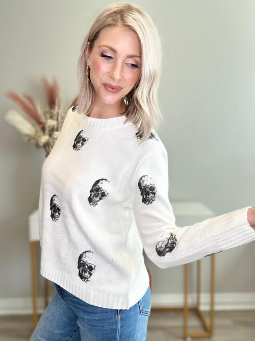 BLACK SKULLS ON CREAM SWEATER